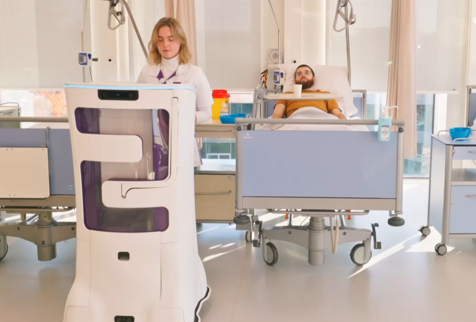 Ambyon ONE, the autonomous hospital delivery robot, delivering medication to a nurse and patient in a hospital